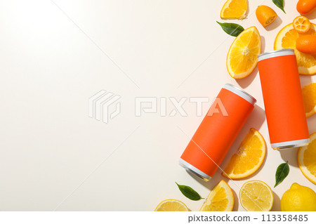 Tin cans and citrus fruits on white background, space for text Tin cans and citrus fruits on white background, space for text 113358485