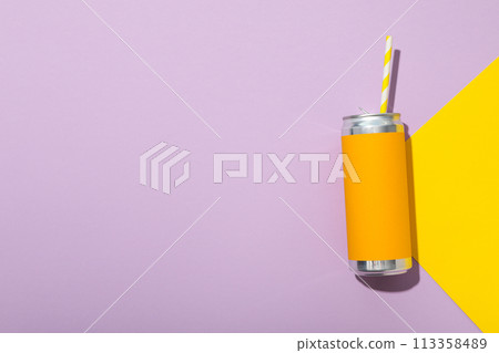 Tin can with straw on purple background, space for text Tin can with straw on purple background, space for text 113358489
