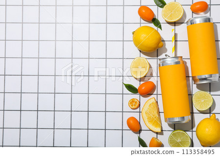 Tin can and citrus fruits on light background, space for text 113358495