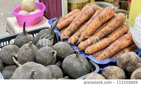 Fresh harvest of carrots and red beets in boxes in the garden. Sale in the supermarket. Autumn harvest, top view. Close-up 113358809