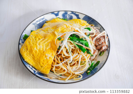Fried noodles with chives and pork topped with egg Fried noodles with chives and pork topped with egg 113359882