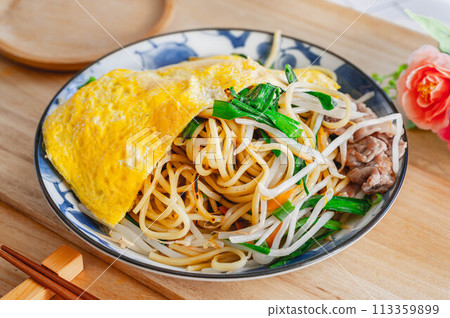 Fried noodles with chives and pork topped with egg Fried noodles with chives and pork topped with egg 113359899