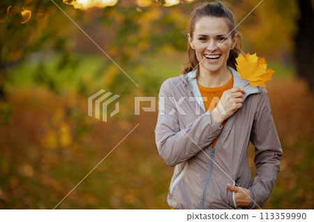 Portrait of happy elegant female in fitness clothes in park 113359990