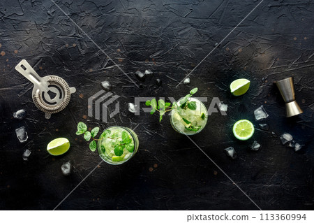 Mojito cocktail. Summer cold drink with lime, fresh mint, and ice. Cool beverage Mojito cocktail. Summer cold drink with lime, fresh mint, and ice. Cool beverage 113360994