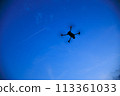 A drone flying in the sunset sky 113361033