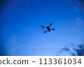 A drone flying in the sunset sky 113361034