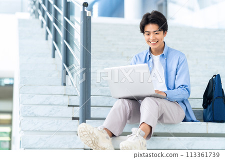 Male college student enjoying campus life 113361739