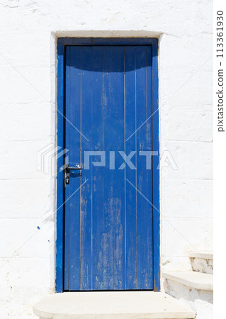 Rustic Blue Door on White Wall. Rustic Blue Door on White Wall. 113361930