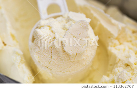Measuring spoon in a bag of dry baby food for preparing milk, close-up 113362707