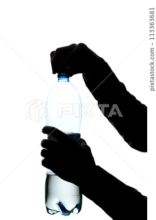 Male hands open a bottle of water to drink - silhouette Male hands open a bottle of water to drink - silhouette 113363681