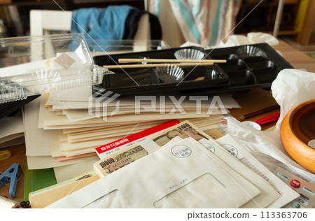 Cash and bankbook found among piles of documents and mail; secret savings; estate sorting; messy room Cash and bankbook found among piles of documents and mail; secret savings; estate sorting; messy room 113363706