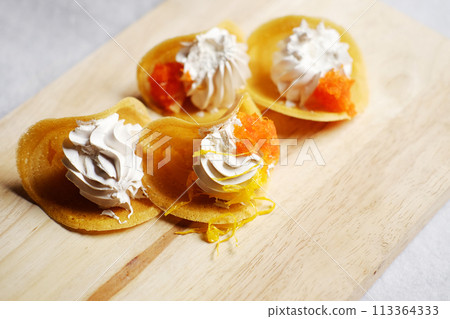 Thai Crispy Pancake (Kanom Buang) on wooden plate isolated on white background Thai Crispy Pancake (Kanom Buang) on wooden plate isolated on white background 113364333