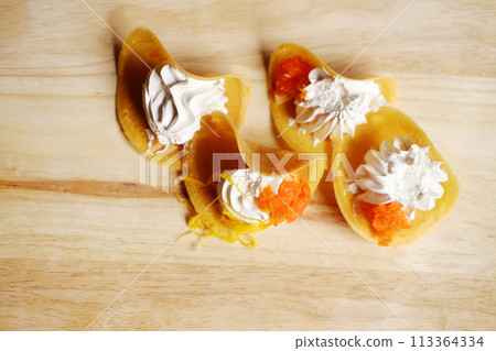 Thai Crispy Pancake (Kanom Buang) on wooden plate isolated on white background 113364334