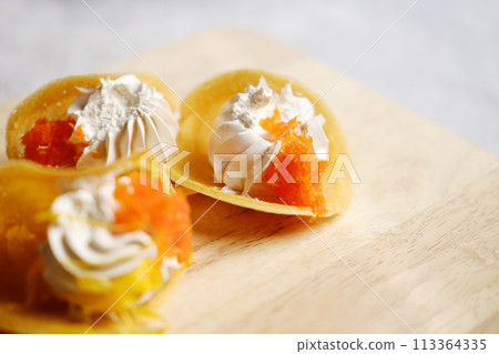 Thai Crispy Pancake (Kanom Buang) on wooden plate isolated on white background 113364335