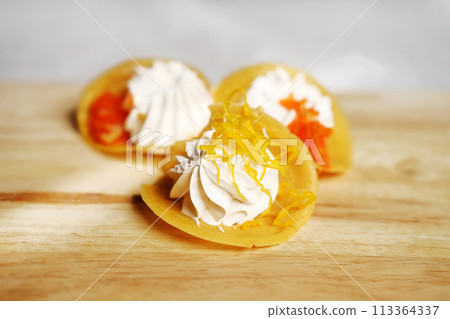 Thai Crispy Pancake (Kanom Buang) on wooden plate isolated on white background 113364337