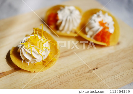 Thai Crispy Pancake (Kanom Buang) on wooden plate isolated on white background 113364339