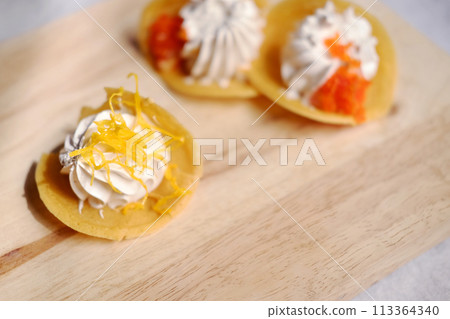 Thai Crispy Pancake (Kanom Buang) on wooden plate isolated on white background Thai Crispy Pancake (Kanom Buang) on wooden plate isolated on white background 113364340