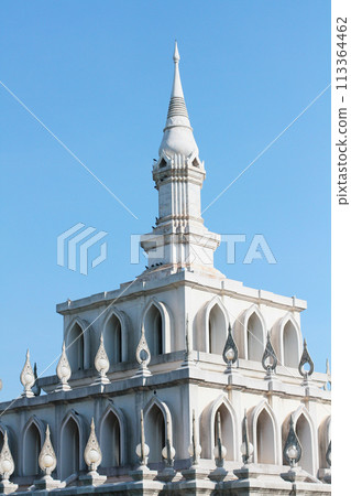 Thai architecture Pavilion of Sukhothai style with blue sky at Sukhothai Thammathirat Open University in Thailand. 113364462