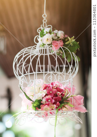 White birdcage decorated with roses flowers hanging decoration in wedding White birdcage decorated with roses flowers hanging decoration in wedding 113364801