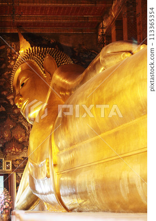 Big golden reclining Buddha image at Wat Pho temple, Thailand. 113365354