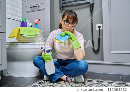 Tired woman sitting on the floor after cleaning the bathroom 113365582