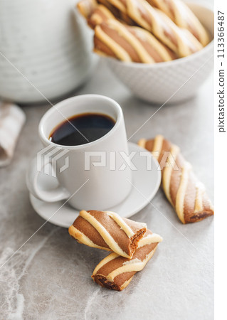 Classic Striped Cookies and coffee cup on kitchen table. Classic Striped Cookies and coffee cup on kitchen table. 113366487