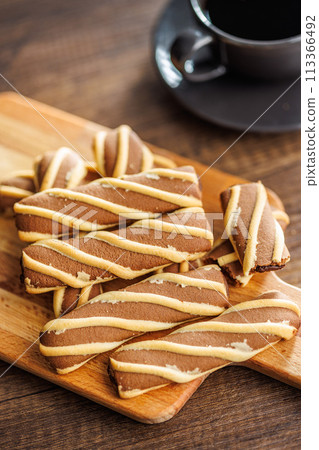 Classic Striped Cookies on cutting board on wooden table. Classic Striped Cookies on cutting board on wooden table. 113366492