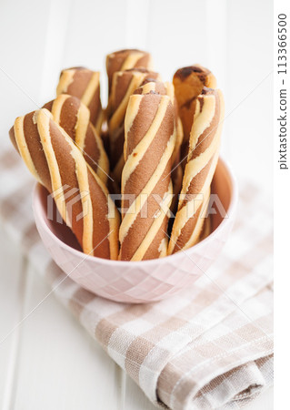 Classic Striped Cookies in bowl on white table. 113366500