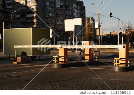Automatic barrier gates for supermarket parking lot. Security system for car park entry to shopping mall. Vehicle entrance with boom barriers and control tickets machine 113366932