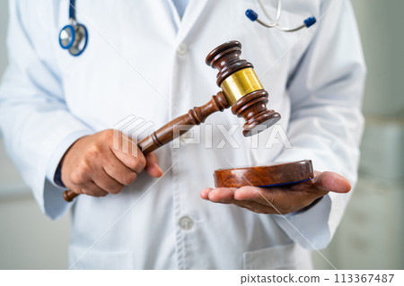 Doctor holding judge gavel, forensic medicine, medical law and crime justice concept. 113367487