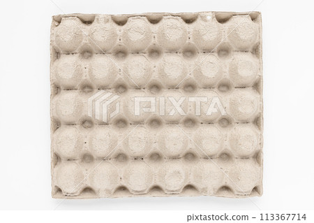 A top view of a beige egg carton displaying symmetrical circular indentations A top view of a beige egg carton displaying symmetrical circular indentations 113367714