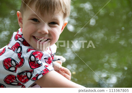 Small boy playing on a pond handsome teenager boy launches kite on the sea in blue sky, close up. High quality photo Small boy playing on a pond handsome teenager boy launches kite on the sea in blue sky, close up. High quality photo 113367805