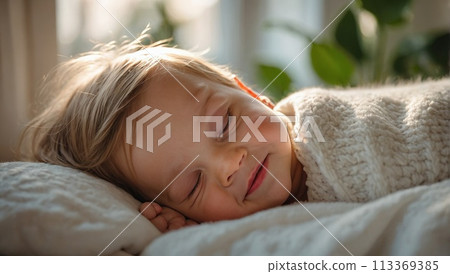 1 Adorable baby boy in white sunny bedroom. Newborn child relaxing in bed. Nursery for young children. Textile and bedding for kids. Family morning at home. New born kid during tummy time with toy 113369385