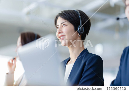 Female operator working at a call center 113369510