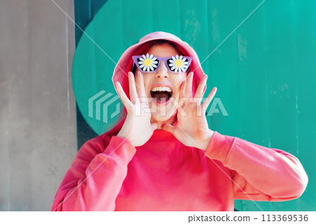 Excited emotional loudly shouting, woman in sunglasses with flowers stickers. Playful woman with pink hair,bucket hat calls out everyone's attention. Vanilla Girl. Kawaii vibe. Candy colors. 113369536