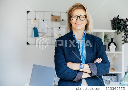 Portrait of smiling 50's stylish, confident mature businesswoman, middle aged company ceo director, experienced senior female professional, business coach team leader in modern office. Female leader Portrait of smiling 50's stylish, confident mature businesswoman, middle aged company ceo director, experienced senior female professional, business coach team leader in modern office. Female leader 113369555