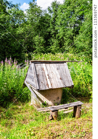 Traditional wooden water well at the countryside in summer Traditional wooden water well at the countryside in summer 113369747