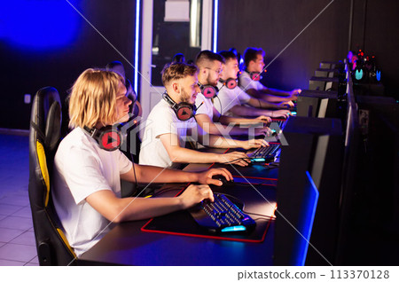 Gamers team plays a video game on PC at computer club, cyber sport tournament. E-sport championship. 5 players in in headset. Multiplayer online battle competition, tactical first-person shooter 113370128