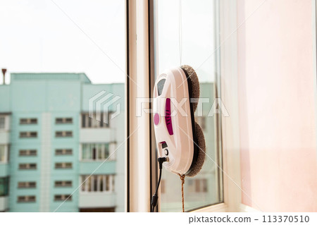 Automatic vacuum robot window washer washes glass from dirt. Modern technology and security Copy space for text Automatic vacuum robot window washer washes glass from dirt. Modern technology and security Copy space for text 113370510