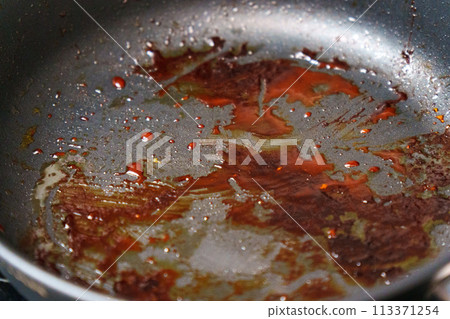 Close Up of Frying Pan With Food Cooking, dirty dishes, grease 113371254