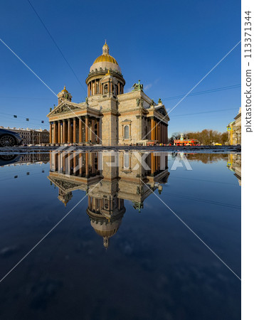 incredible reflection in spring puddles of St. Isaac's Cathedral in St. Petersburg - Russia at sunny eather 113371344