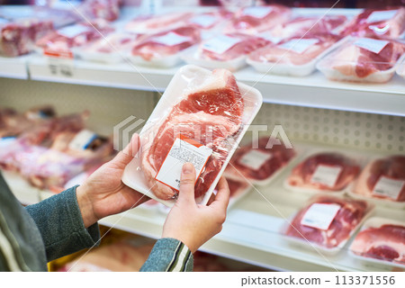Buyer hands with pork meat at grocery Buyer hands with pork meat at grocery 113371556