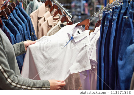 Buyer woman chooses clothes in store Buyer woman chooses clothes in store 113371558