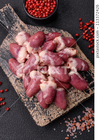Raw chicken hearts with salt, spices and herbs 113372426