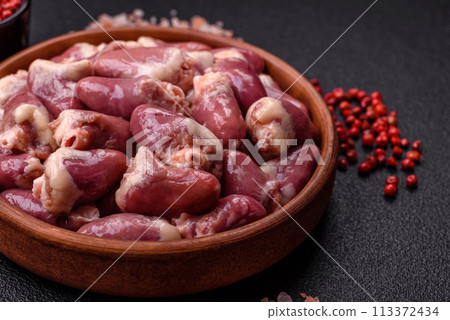 Raw chicken hearts with salt, spices and herbs Raw chicken hearts with salt, spices and herbs 113372434