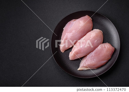Fresh chicken fillet on a dark concrete table with spices and herbs 113372470