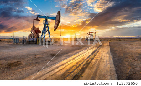 Oil well station in the desert with a beautiful sky sunset 113372656