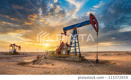 Oil well station in the desert with a beautiful sky sunset 113372659
