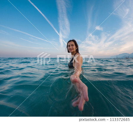 Woman on tropical vacation paradise on sea. Summer sea joy in Turkish seacoast, beaches along Lycian Way, Turkish Riviera. Asian female underwater and turquoise ocean around. Woman on tropical vacation paradise on sea. Summer sea joy in Turkish seacoast, beaches along Lycian Way, Turkish Riviera. Asian female underwater and turquoise ocean around. 113372685