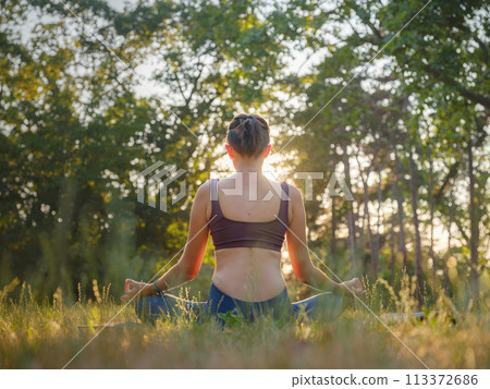 Young asian woman doing meditation in morning or evening at park, healthy woman relaxing and practicing yoga at city park. Mindfulness, destress, Healthy habits and balance concept Young asian woman doing meditation in morning or evening at park, healthy woman relaxing and practicing yoga at city park. Mindfulness, destress, Healthy habits and balance concept 113372686